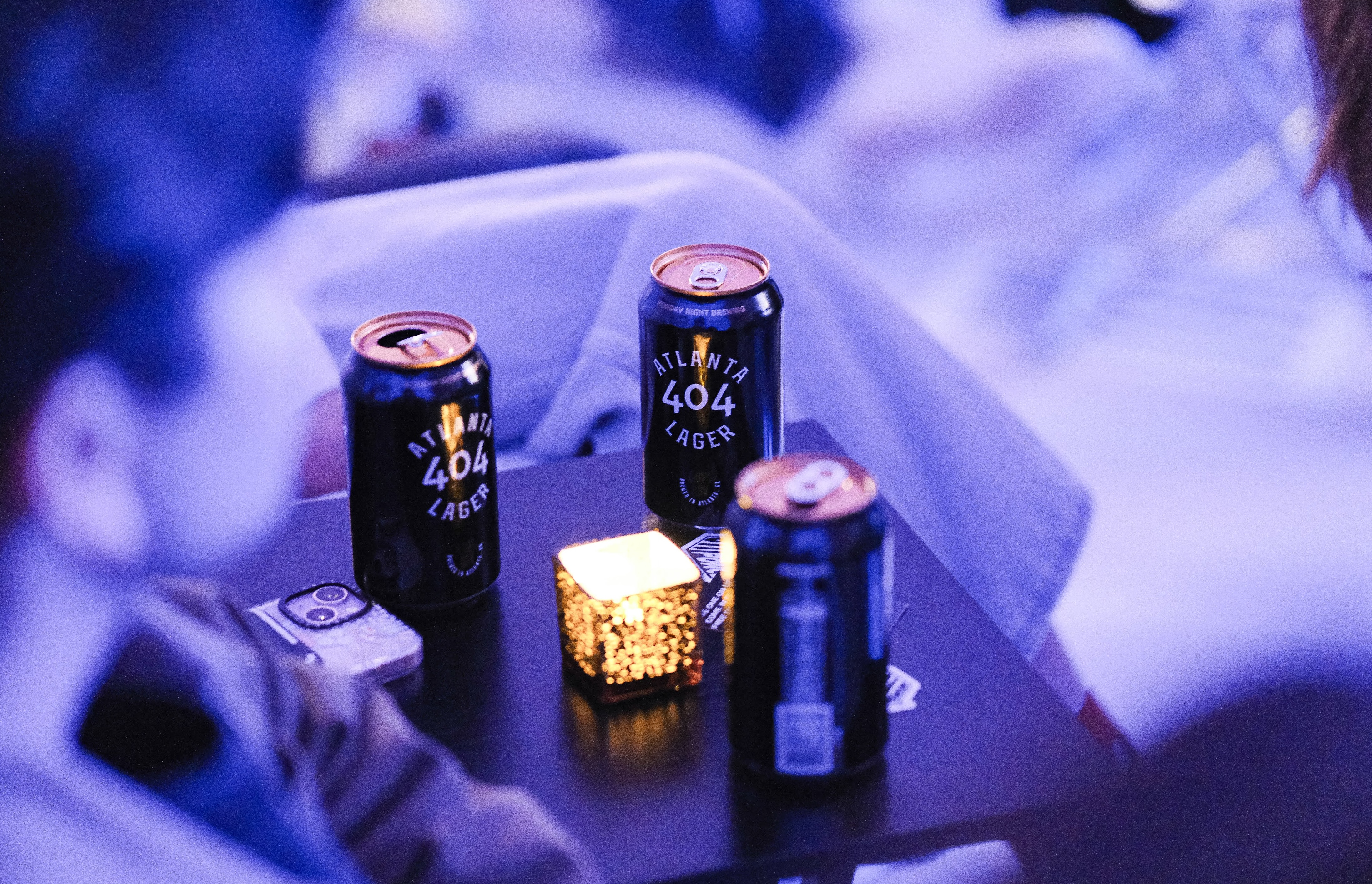 404 Atlanta Lager cans in moody blue light
