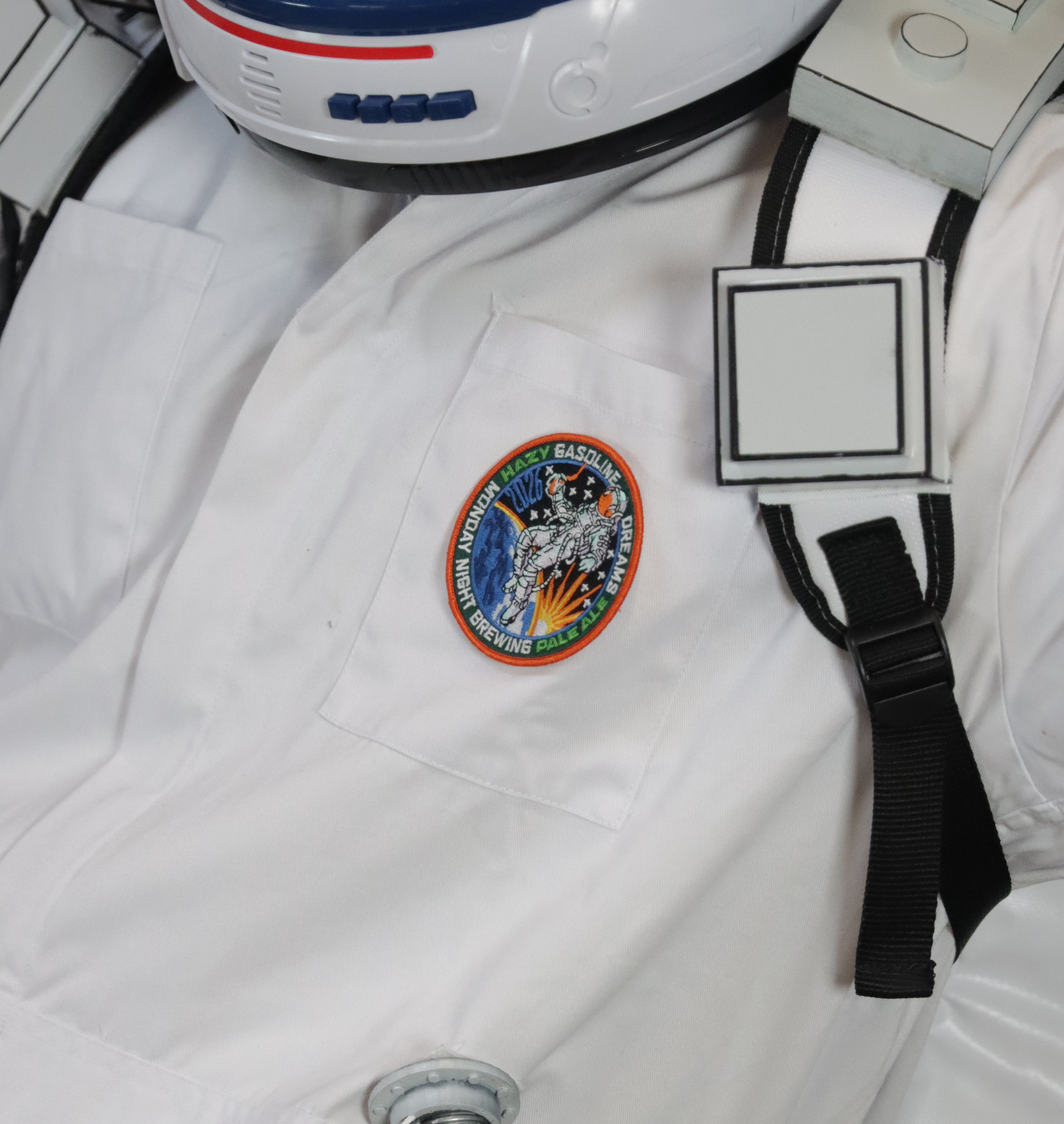 Close-up of the embroidered Gasoline Dreams mission patch on the Hopstronaut suit
